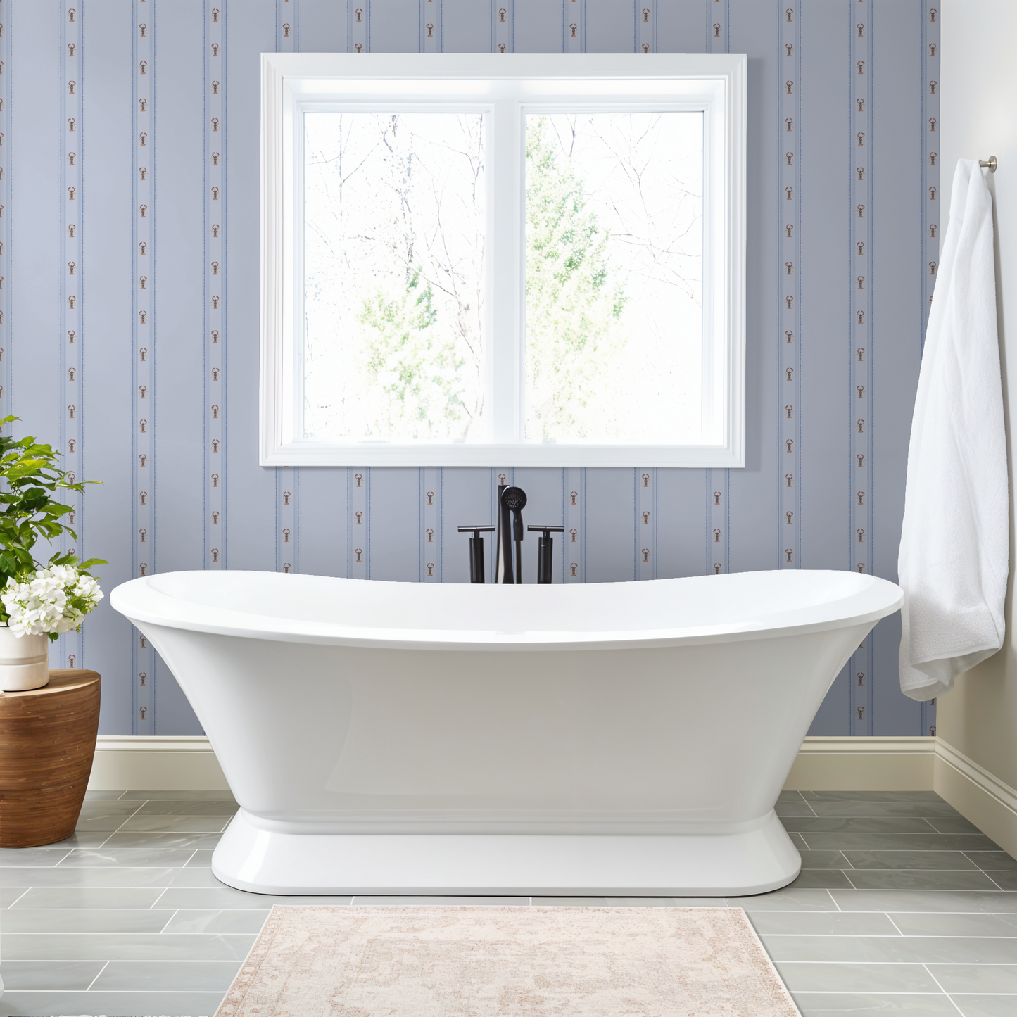 White freestanding bathtub in a bathroom with a framed picture on the wall.