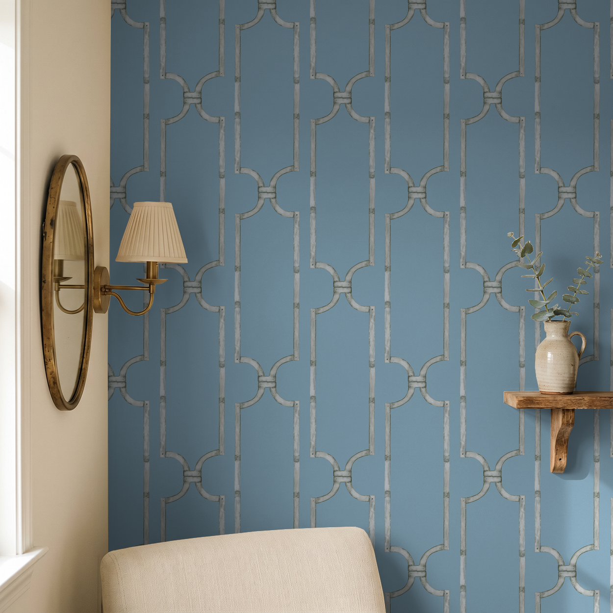 Blue trellis wallpaper in elegant living room with mirror and shelf decor.