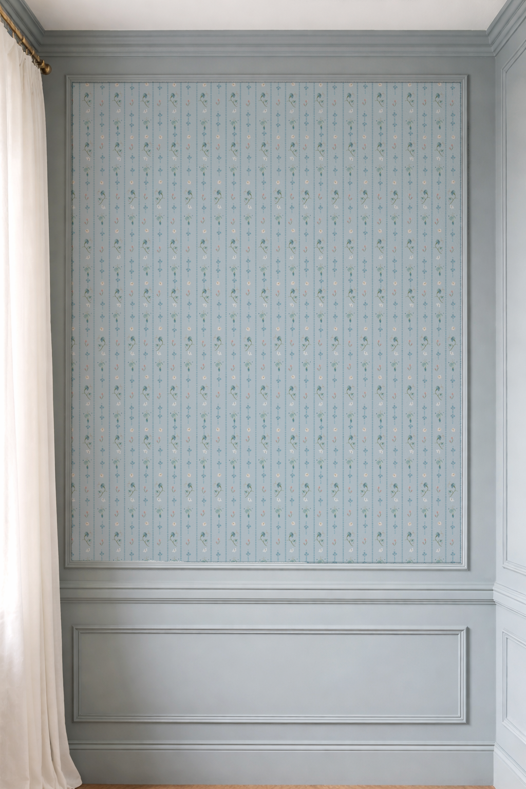 Wall with decorative paneling and light blue patterned wallpaper
