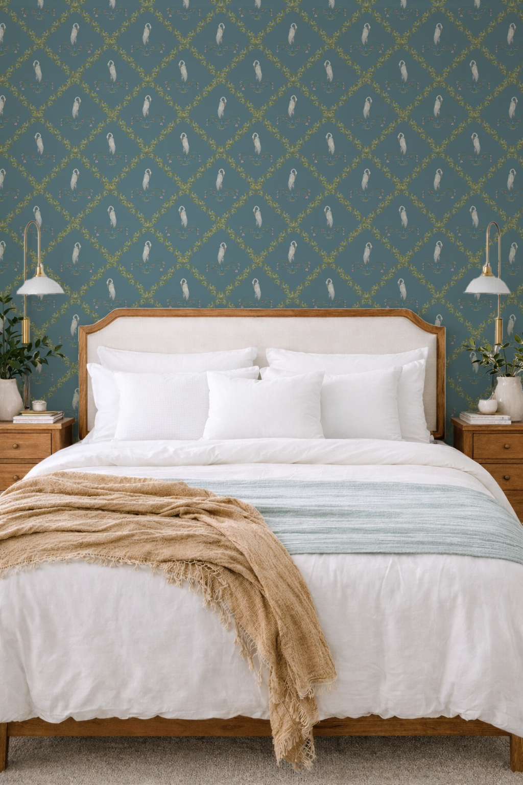 Bedroom with wooden bed, white bedding, and decorative pillows against a patterned blue wall.