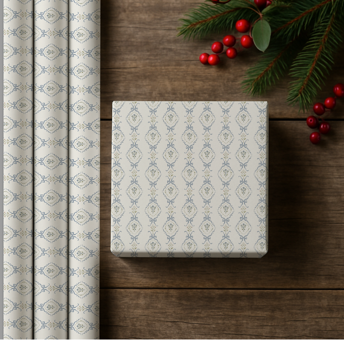 Patterned gift wrap roll and box on a wooden surface with Christmas decorations.