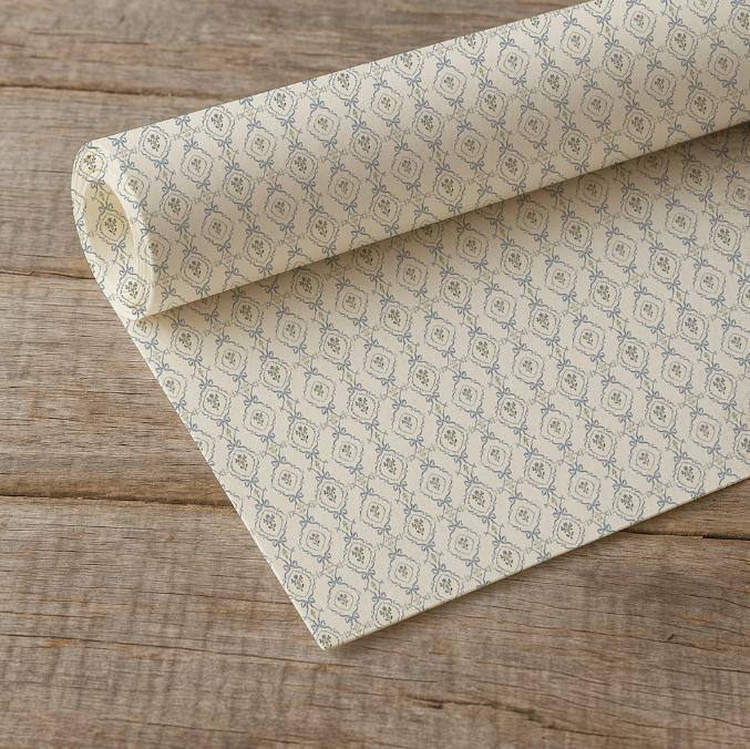 Rolled-up patterned paper on a wooden surface