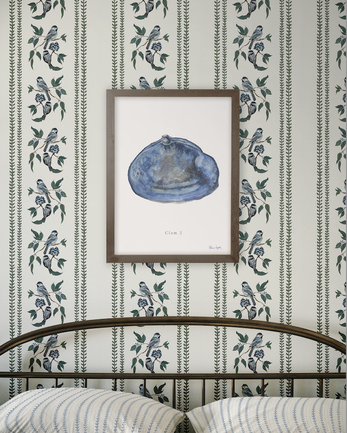Framed artwork of a blue shell on a wall with decorative floral pattern