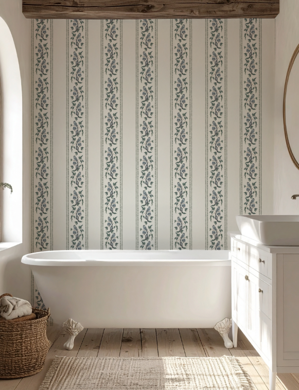 Bathroom with a freestanding bathtub, patterned wallpaper, and wooden floor.