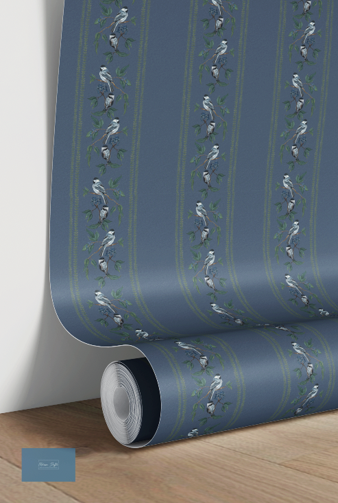 Roll of blue wallpaper with bird pattern on a wooden surface