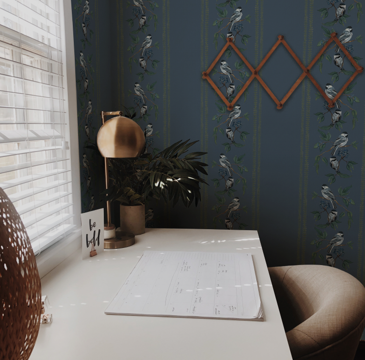Room interior with a desk, plant, and decorative wall art.