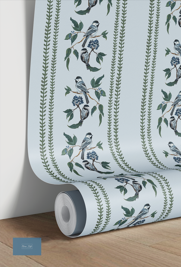 Roll of wallpaper with bird and leaf design on a light blue background