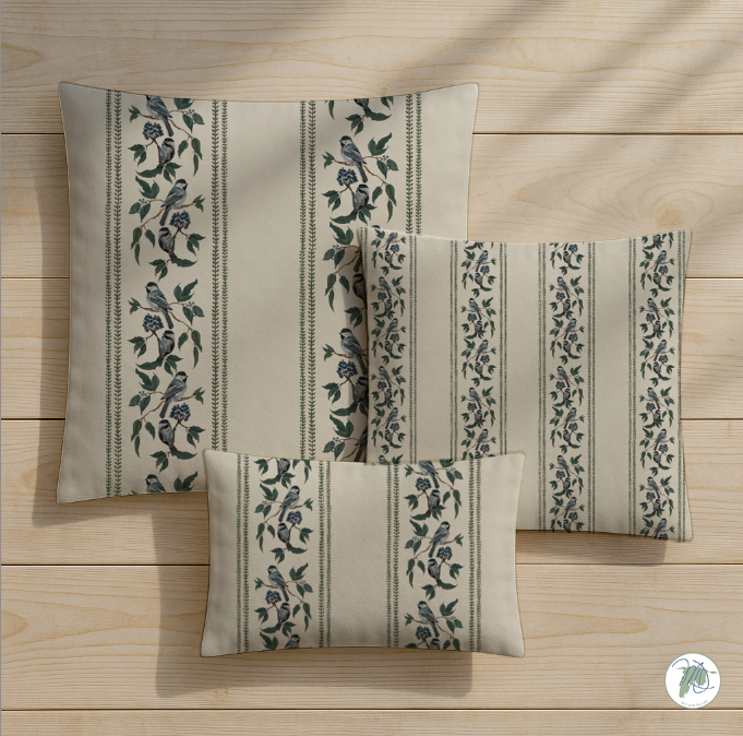 Set of three decorative pillows with floral patterns on a wooden surface