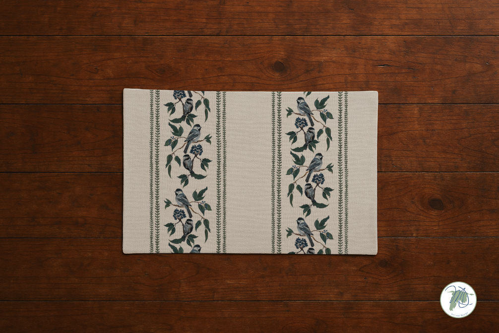 Decorative mat with bird and floral patterns on a wooden floor