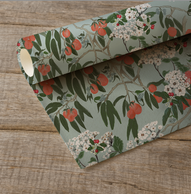 Floral and fruit patterned paper on a wooden surface