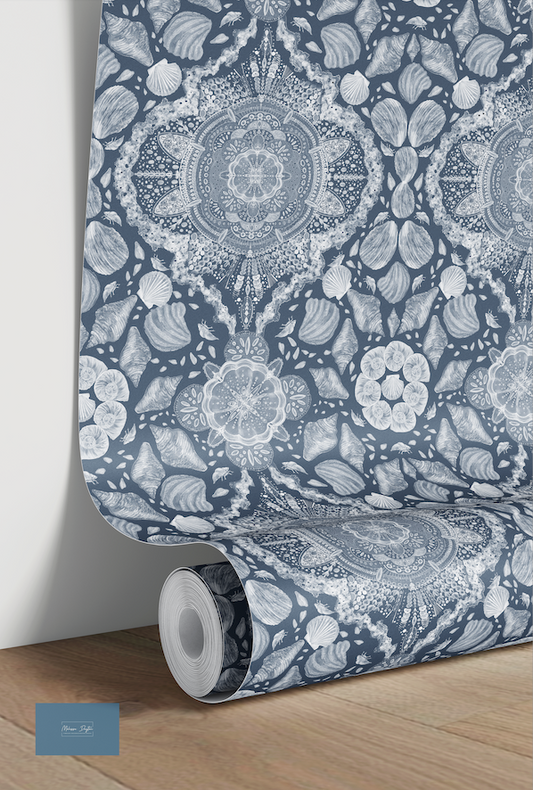 Roll of wallpaper with a blue and white floral pattern on a wooden floor.