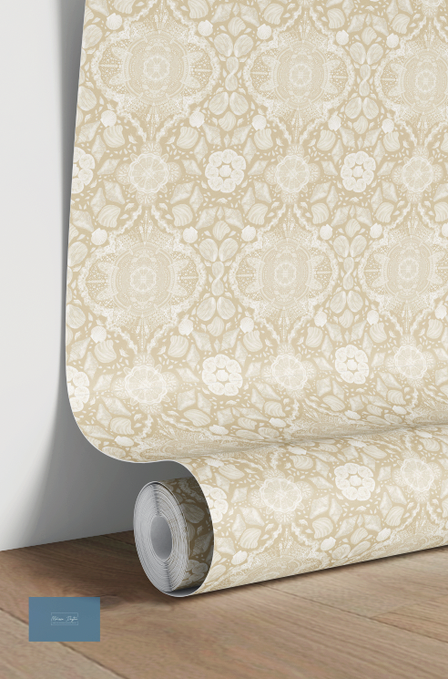 Roll of beige floral patterned wallpaper on a wooden floor.