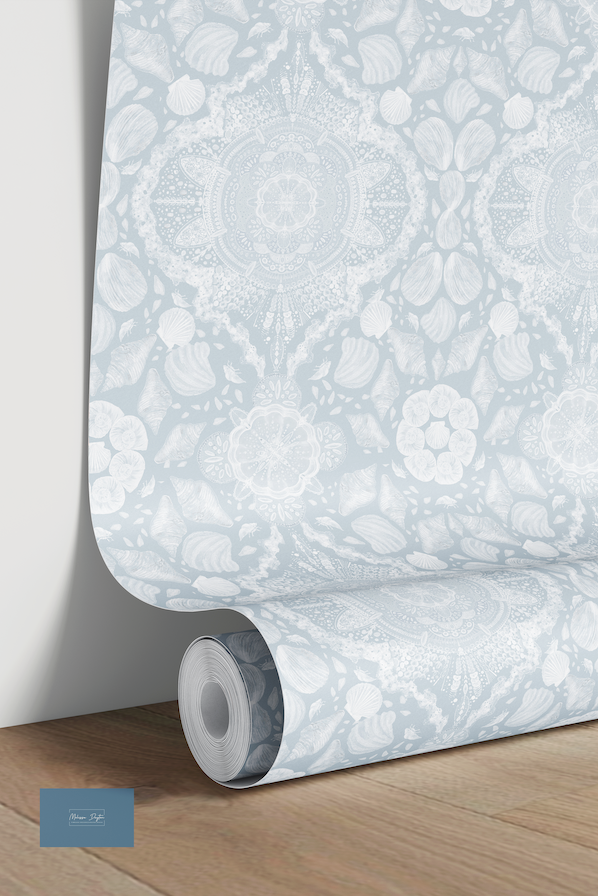 Roll of floral wallpaper on a wooden floor with a neutral background