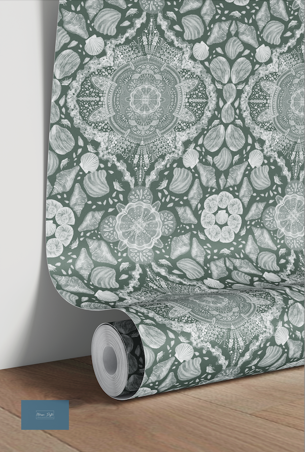 Roll of decorative wallpaper with intricate patterns on a wooden floor.