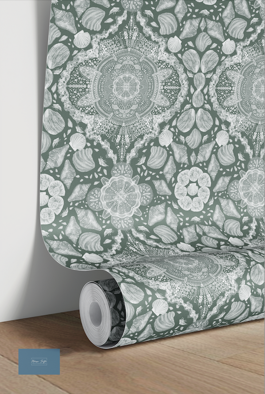 Roll of decorative wallpaper with intricate patterns on a wooden floor.