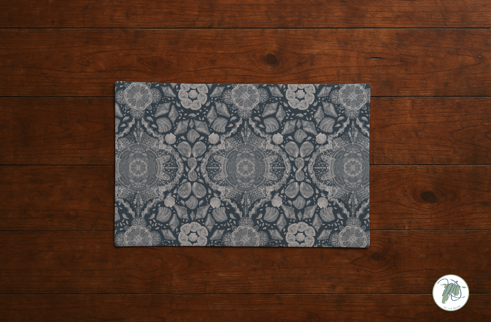 Decorative doormat with a geometric pattern on a wooden floor