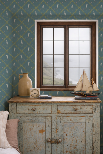 Vintage-style room with a window, wooden cabinet, and decorative items against a patterned wall.