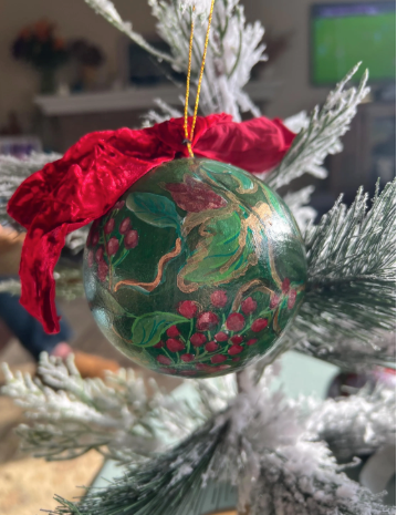 Decorative Christmas ball ornament with red bow on a tree