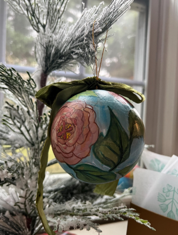 Decorative ornament with floral design on a tree branch