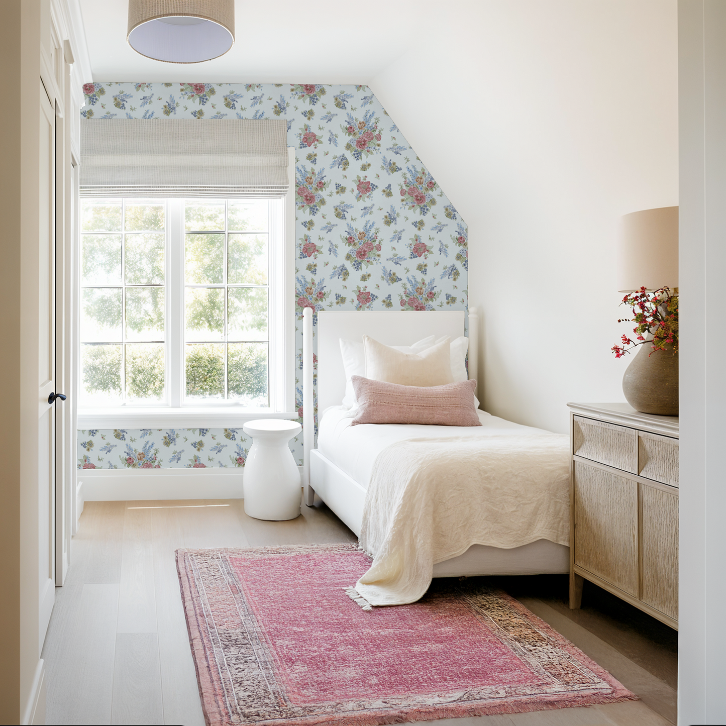 Neatly decorated bedroom with a bed, nightstand, and pink rug.
