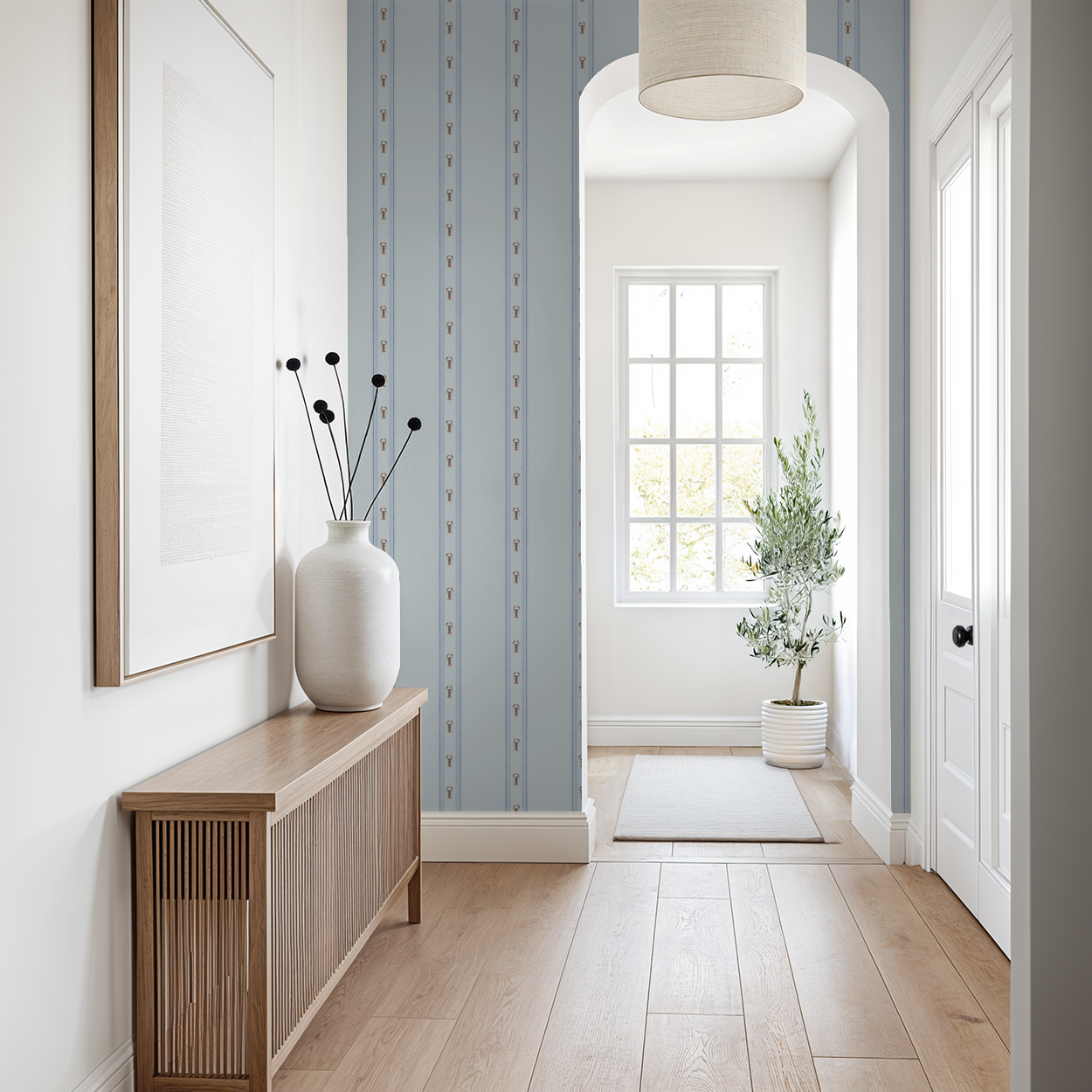 Modern interior hallway with wooden console table, framed picture, and decorative elements.