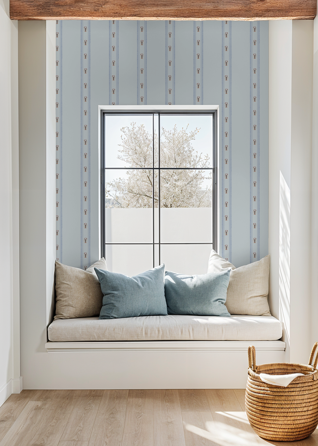 Window seat with cushions and a woven basket in a room with light blue striped wallpaper.