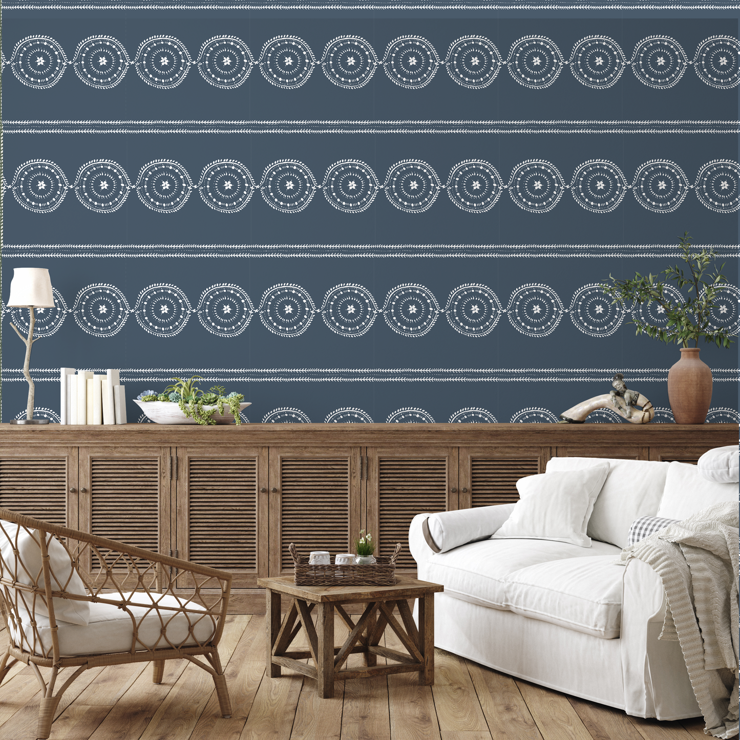 Living room with blue patterned wallpaper, wooden furniture, and white sofa.