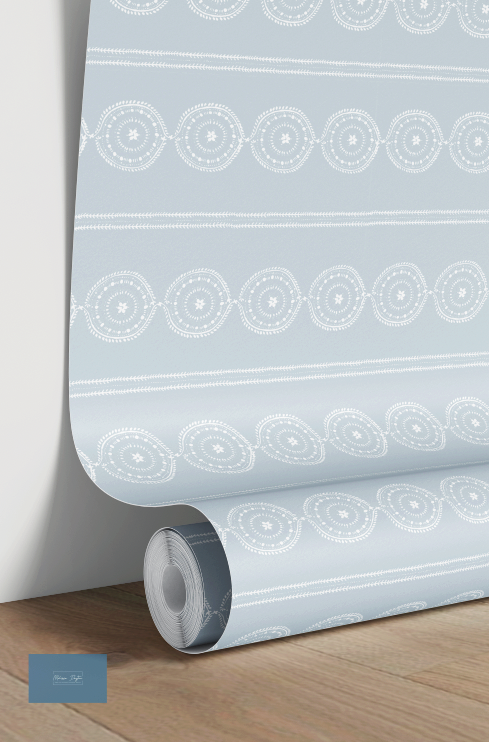 Roll of wallpaper with geometric pattern on a wooden floor and light gray wall background