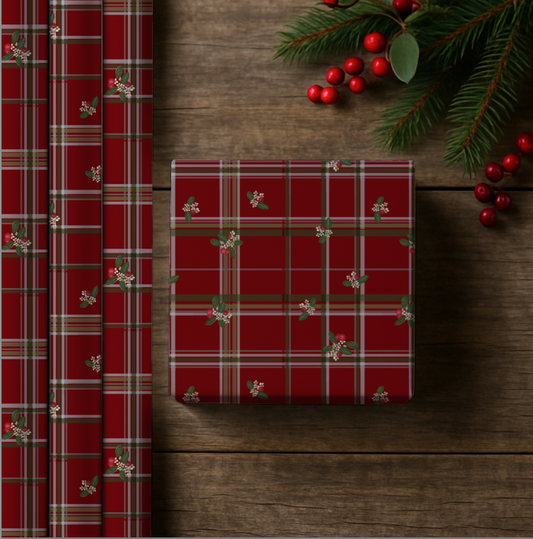 Red plaid wrapping paper with Christmas decorations on a wooden surface