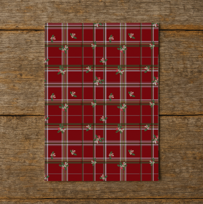 Red plaid paper with floral patterns on a wooden surface