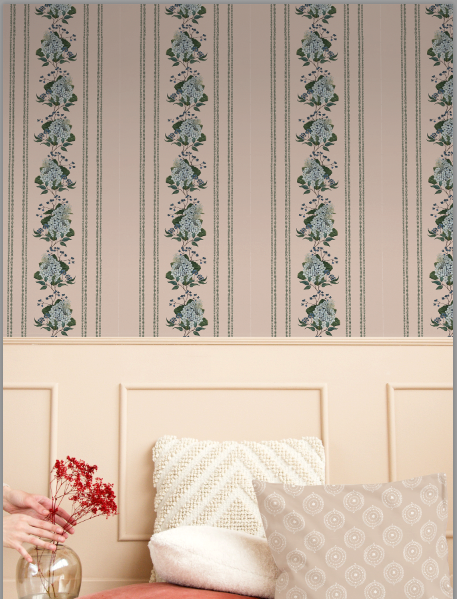 Wallpaper with floral stripe design on a wall above a bed with pillows.