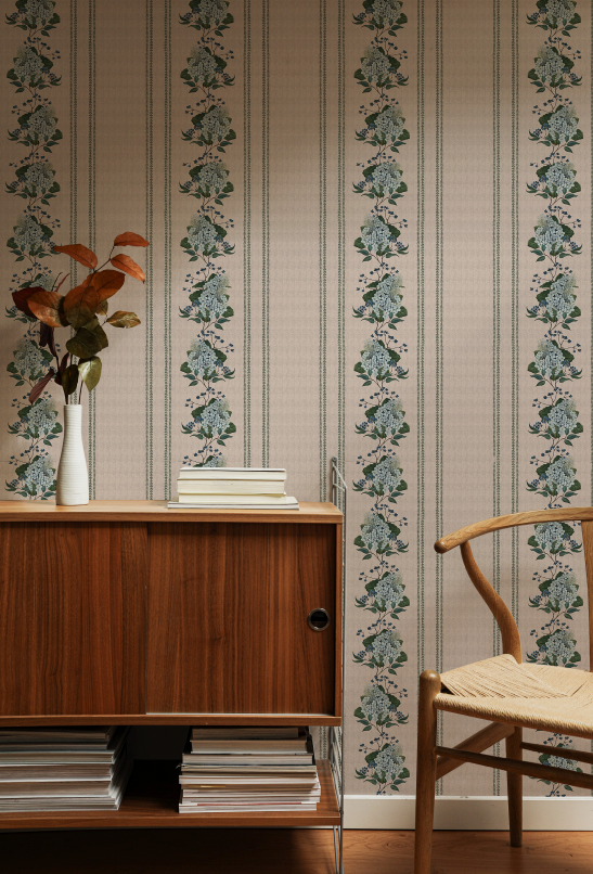 Room interior with wooden cabinet, chair, and floral-patterned wallpaper