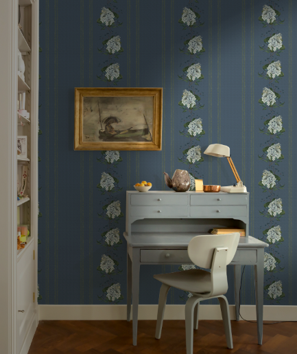 Vintage-style room with a desk, chair, and decorative wallpaper.