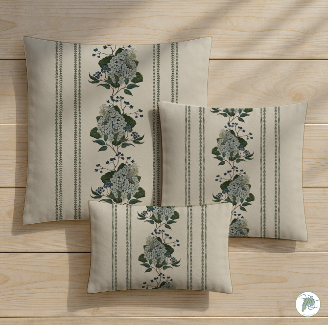 Set of three decorative pillows with floral patterns on a wooden surface
