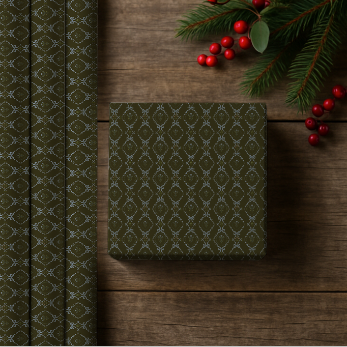 Green patterned gift box on a wooden surface with Christmas decorations.
