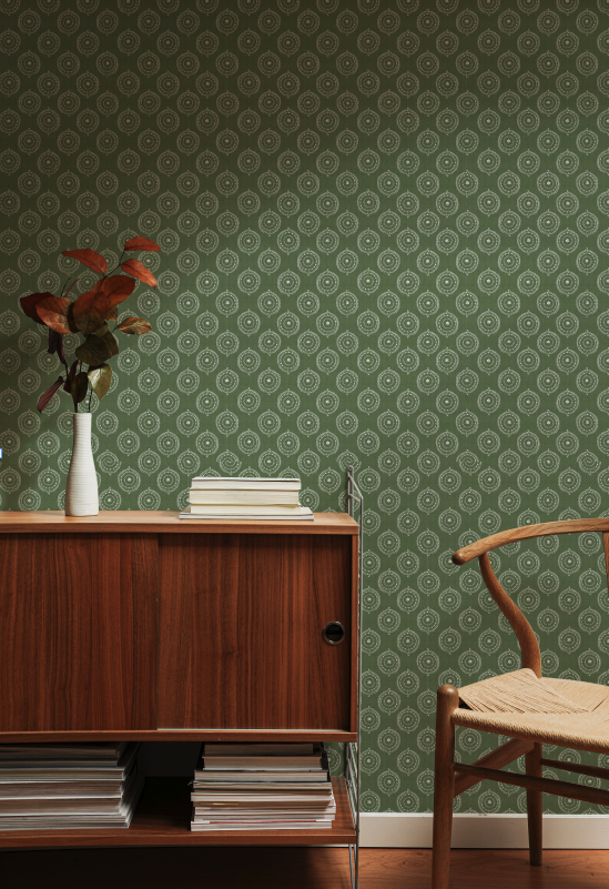 Room interior with wooden cabinet, chair, and patterned green wallpaper