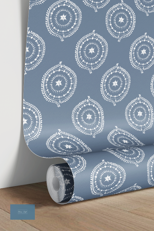 Roll of blue wallpaper with white circular pattern on a wooden floor.