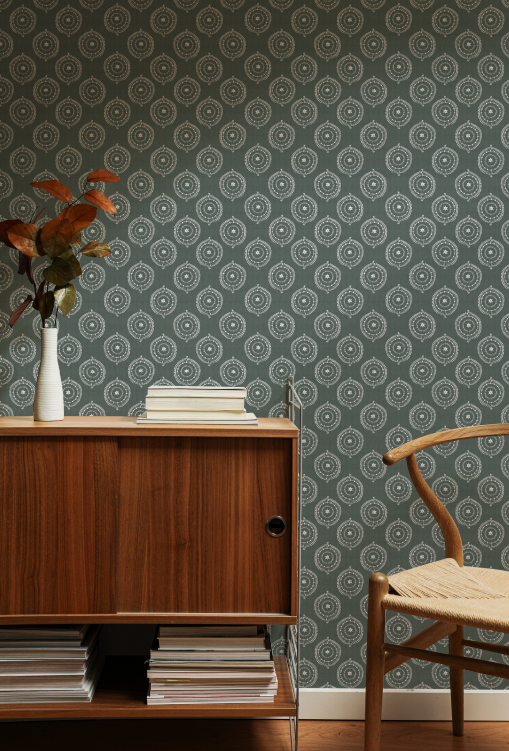 Room interior with wooden sideboard, chair, and patterned wallpaper