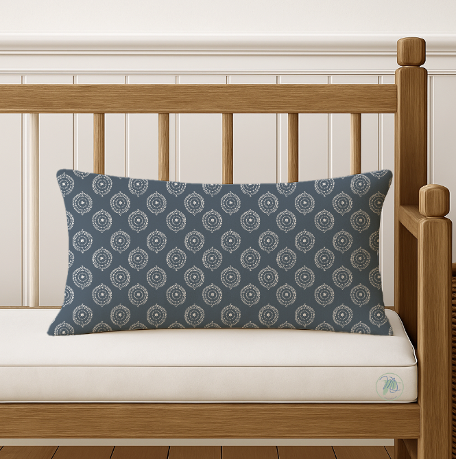 Decorative pillow with a blue pattern on a wooden bench.