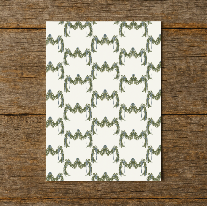 Patterned paper with green leaf design on a wooden surface