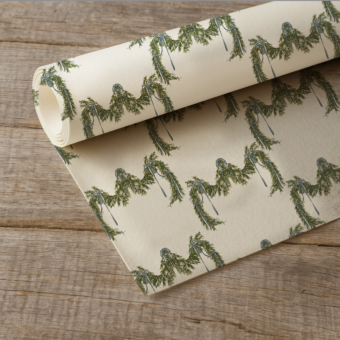 Roll of paper with green tree pattern on a wooden surface