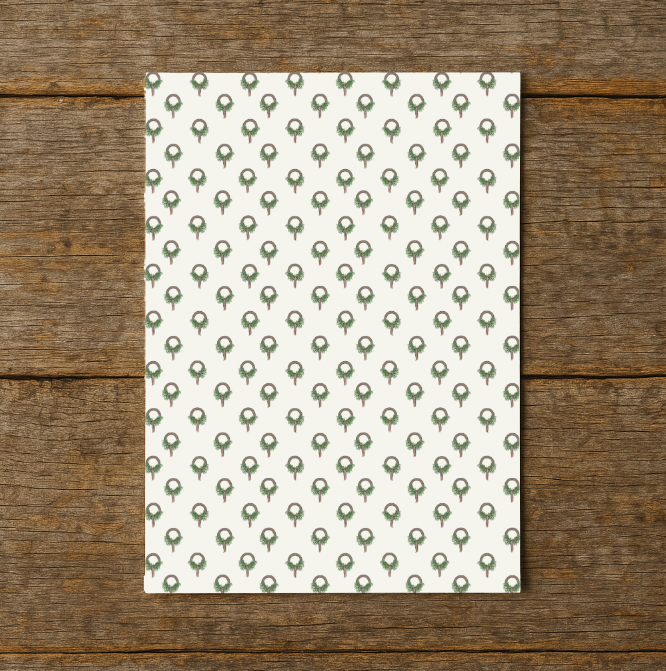 wrapping paper with green tree pattern on a wooden surface