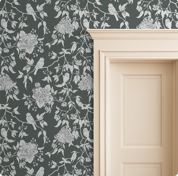 Floral and bird patterned wallpaper on a wall with a wooden door.