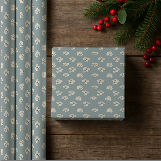 Gift box with floral pattern on a wooden surface with Christmas decorations