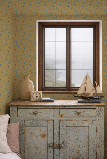 Vintage-style room with floral wallpaper, wooden cabinet, and window view.