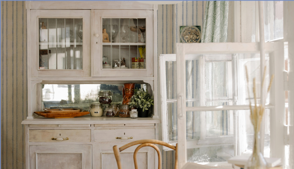 Dining room with a wooden chair, table, and decorative items.