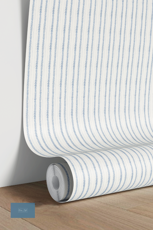 Roll of blue and white striped wallpaper on a wooden surface with a light gray wall background.