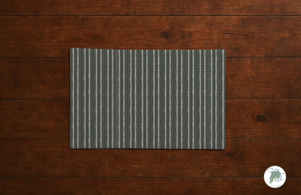 Gray striped placemat on a wooden surface