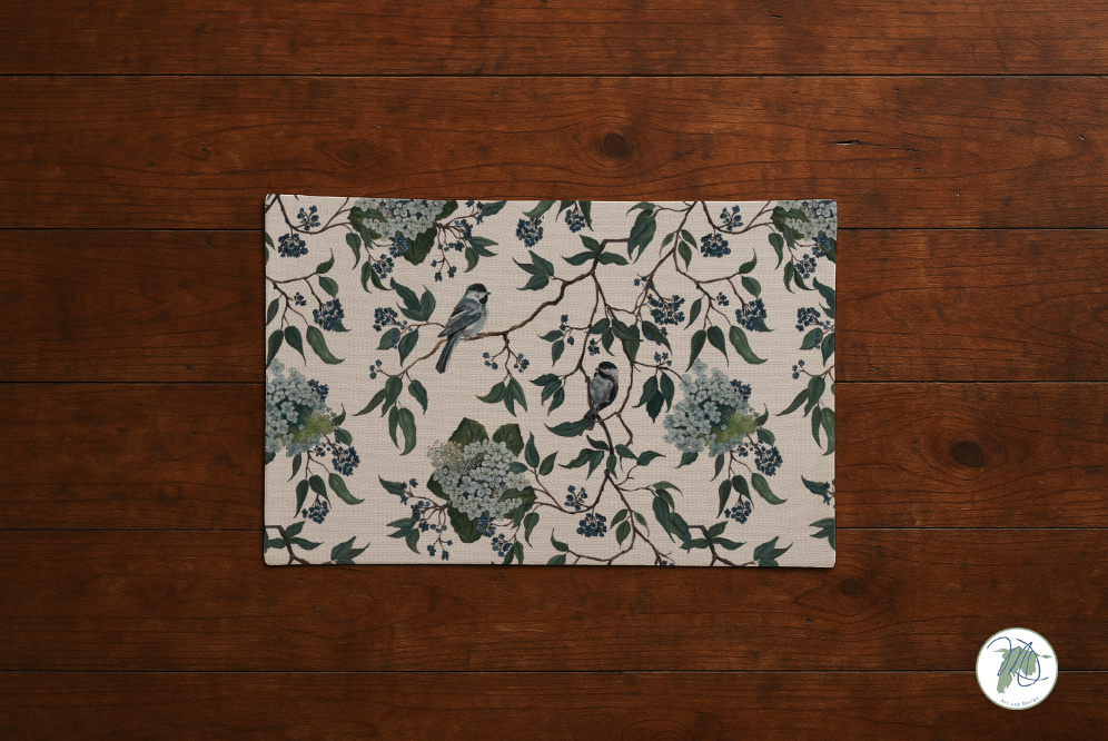 Decorative mat with floral and bird pattern on a wooden floor