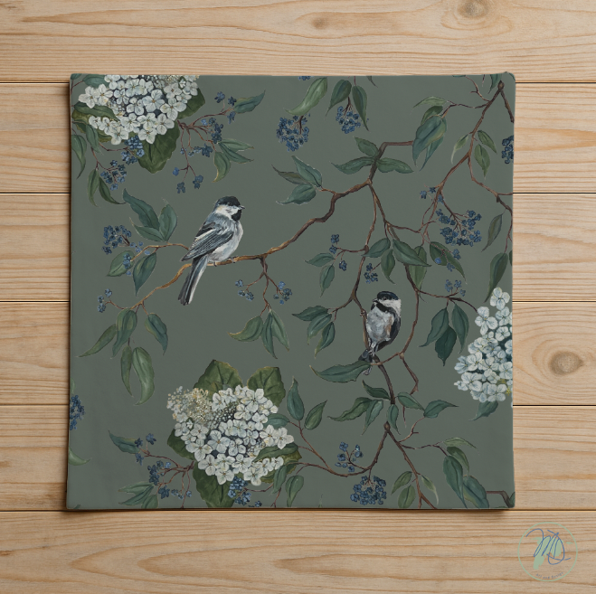 Decorative mat with floral and bird pattern on a wooden surface